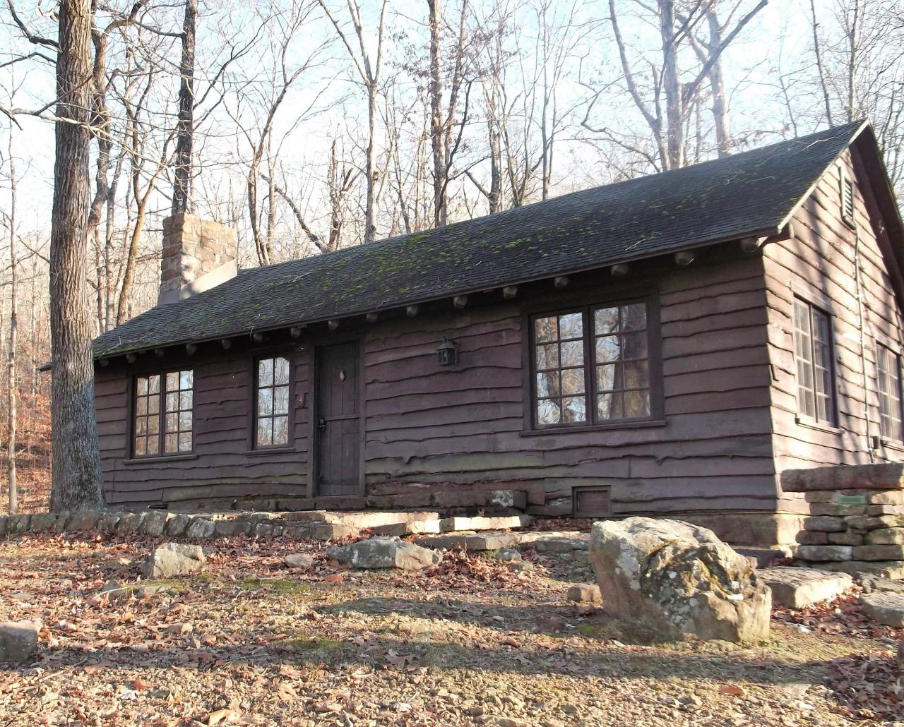 Exterior view of the front entrance of Cabin 4 with front door and stone steps leading to front door